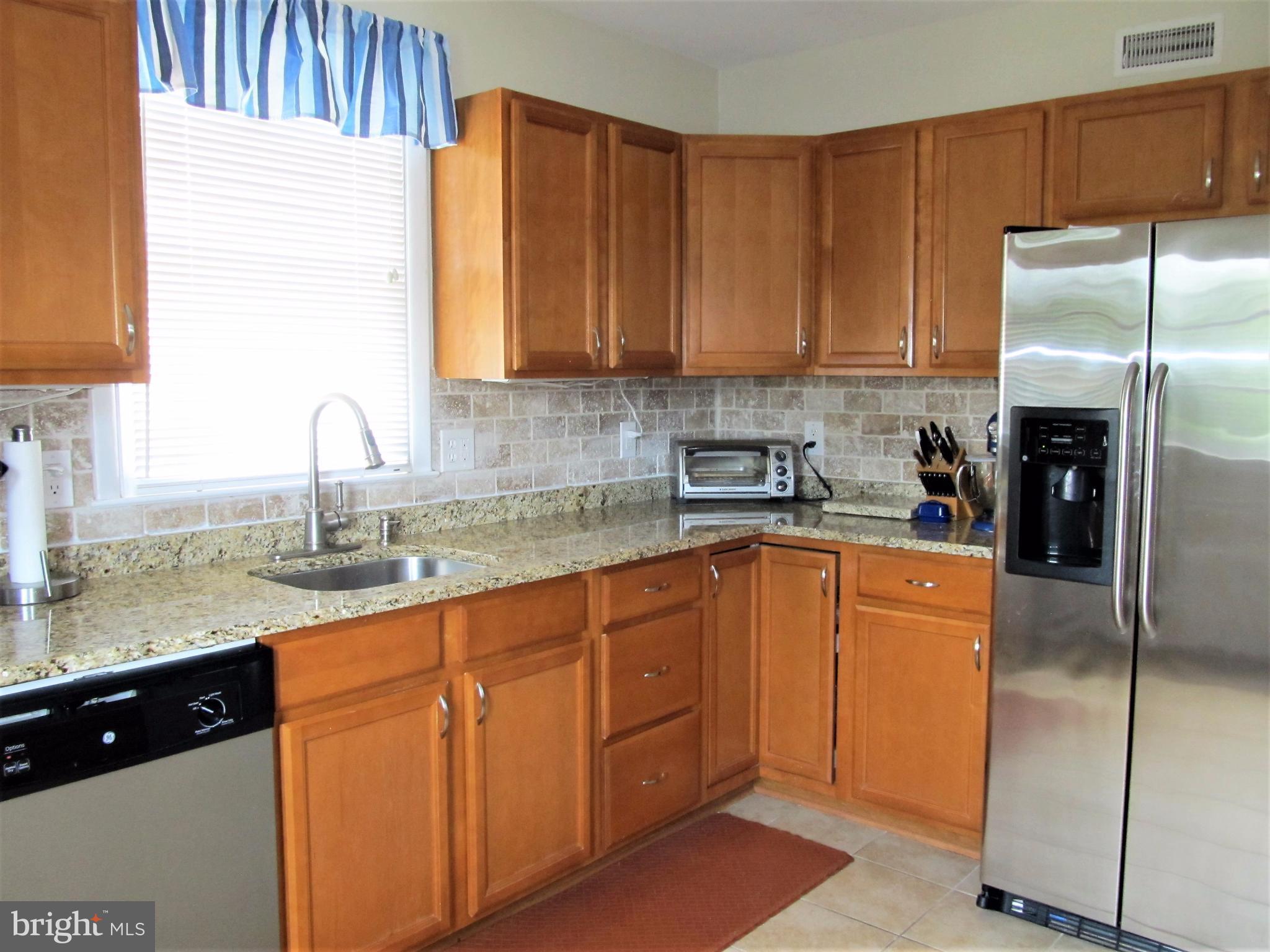 558 Fairmount Road Linthicum Heights, MD 21090 - Photo 5 of 30 a kitchen with stainless steel appliances granite countertop a sink refrigerator and cabinets