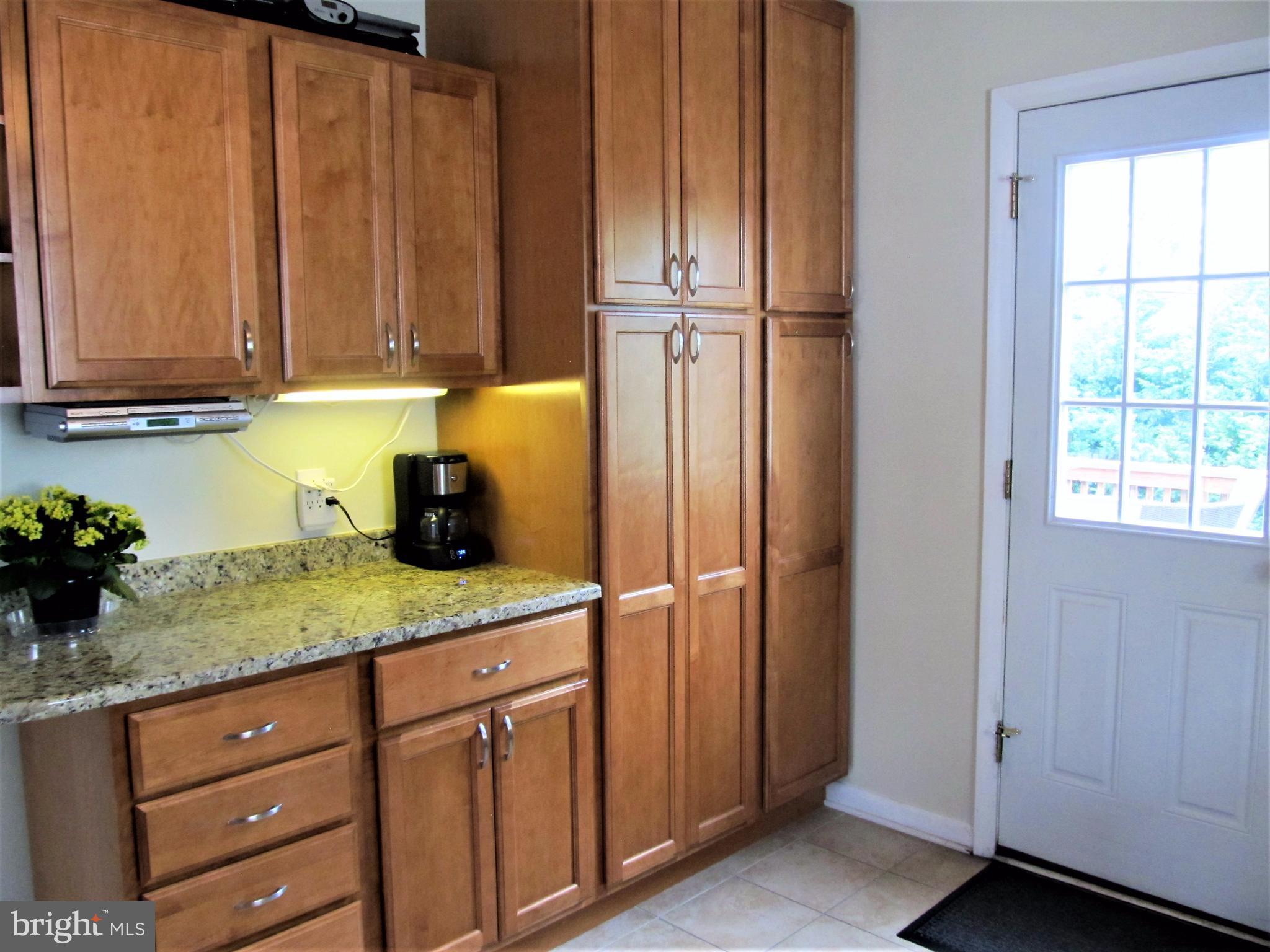 558 Fairmount Road Linthicum Heights, MD 21090 - Photo 7 of 30 a kitchen with a refrigerator and cabinets