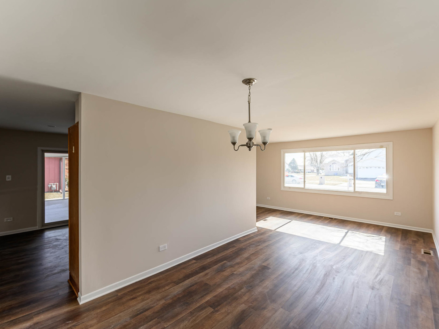 624 Farmview Road University Park, IL 60484 - Photo 3 of 16 an empty room with wooden floor fan and windows