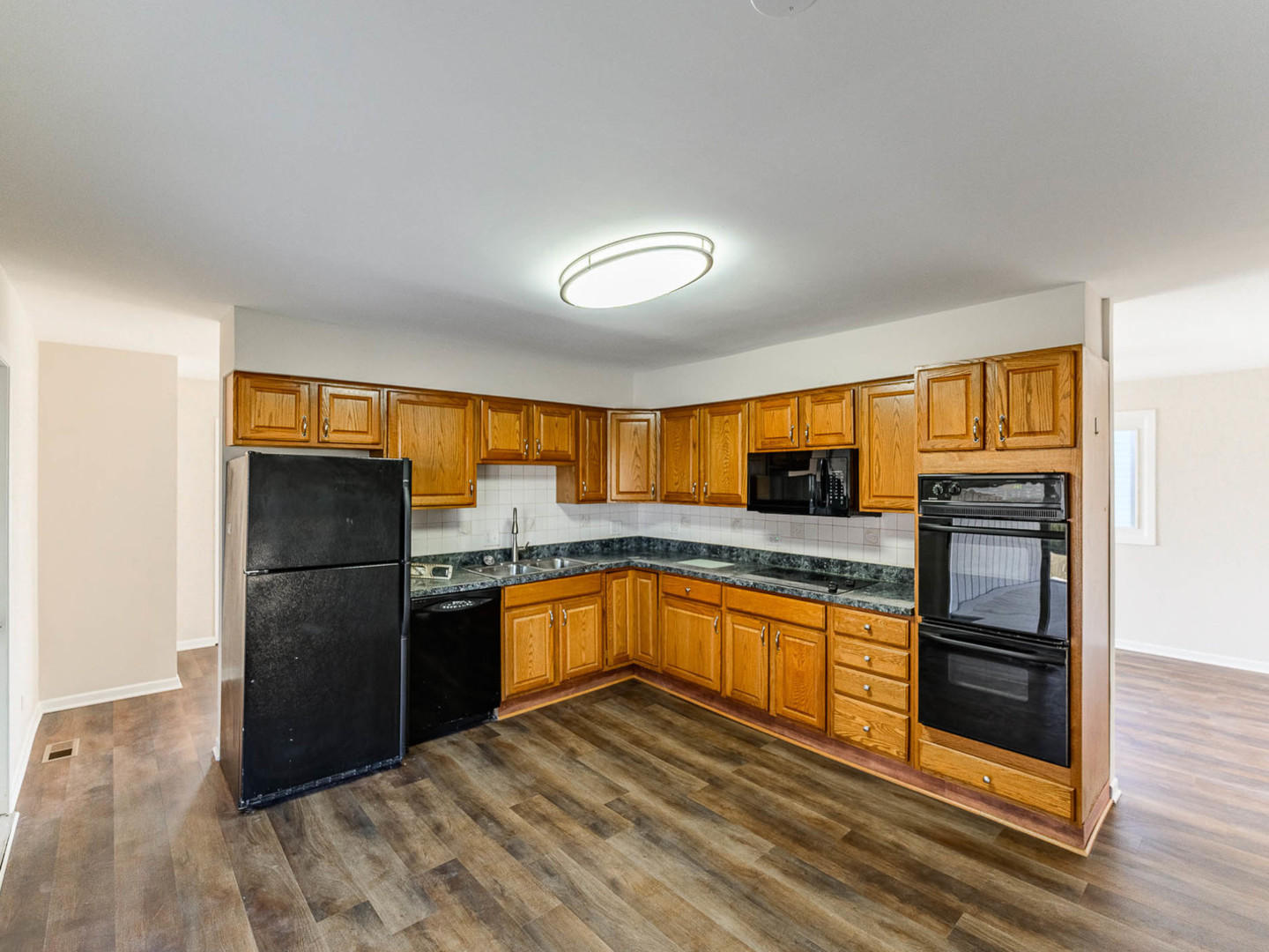 624 Farmview Road University Park, IL 60484 - Photo 5 of 16 a kitchen with granite countertop a refrigerator and a sink