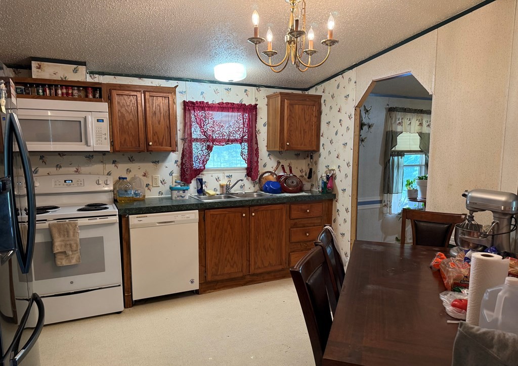 920 Pioneer Road Grimsley, TN 38565 - Photo 12 of 15 a kitchen with stainless steel appliances granite countertop a stove refrigerator and cabinets