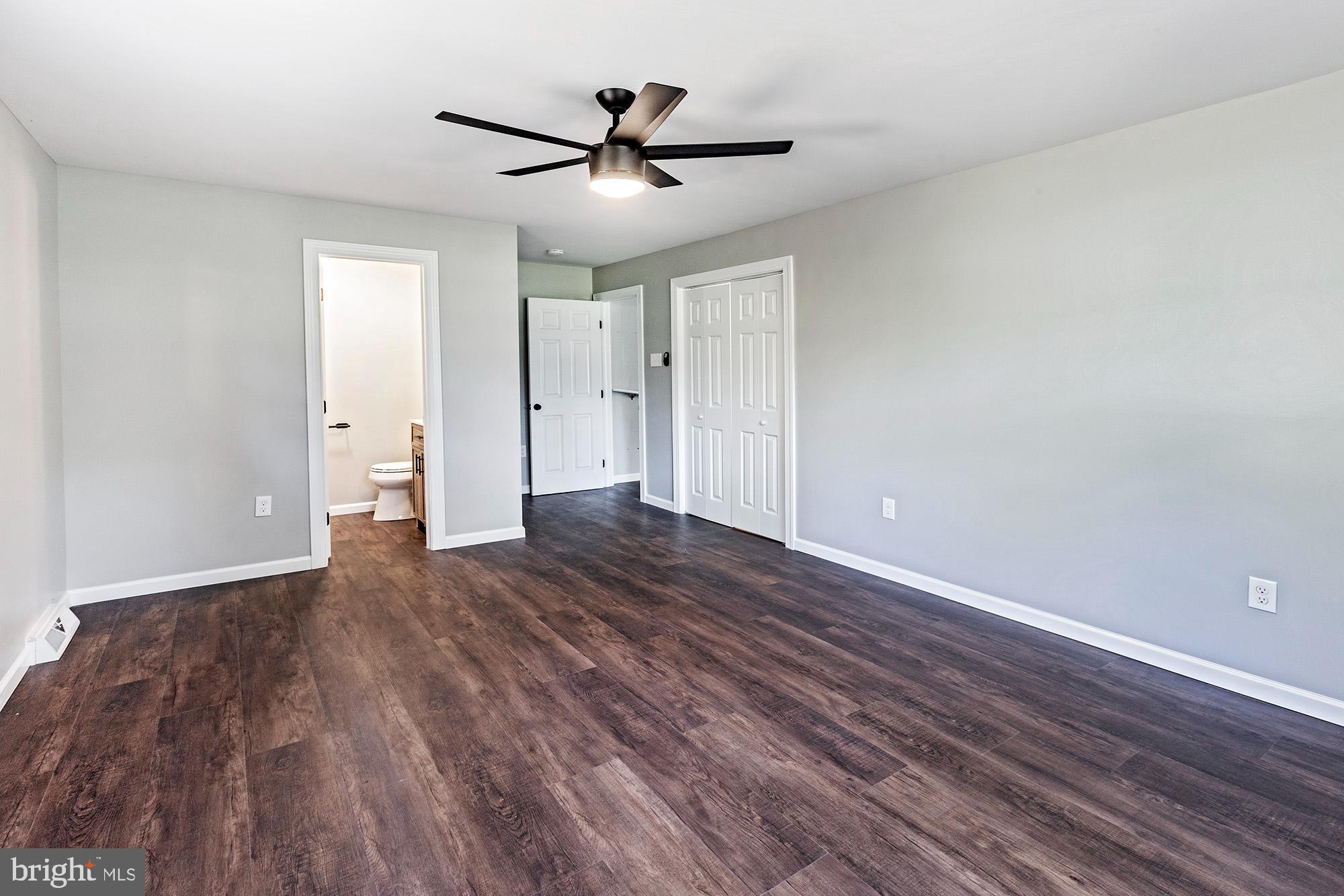 78 North Hook Road Pennsville, NJ 08070 - Photo 11 of 26 a view of a livingroom with wooden floor and a ceiling fan