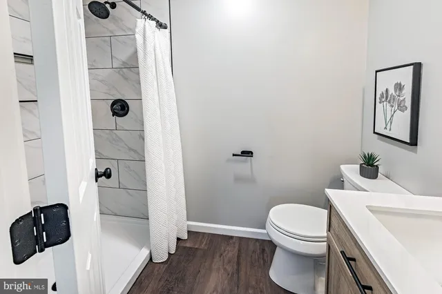 a bathroom with a toilet and a shower