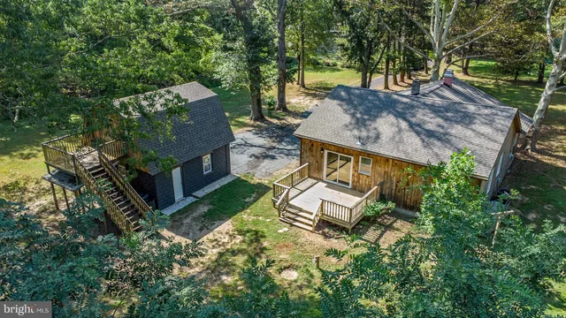 an aerial view of a house with garden space and street view