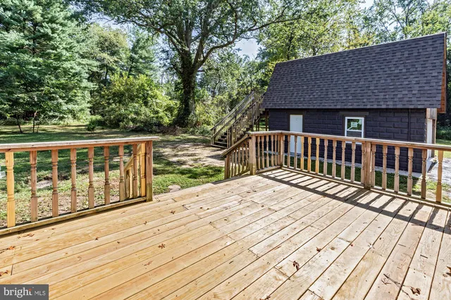 a view of wooden house with a bench