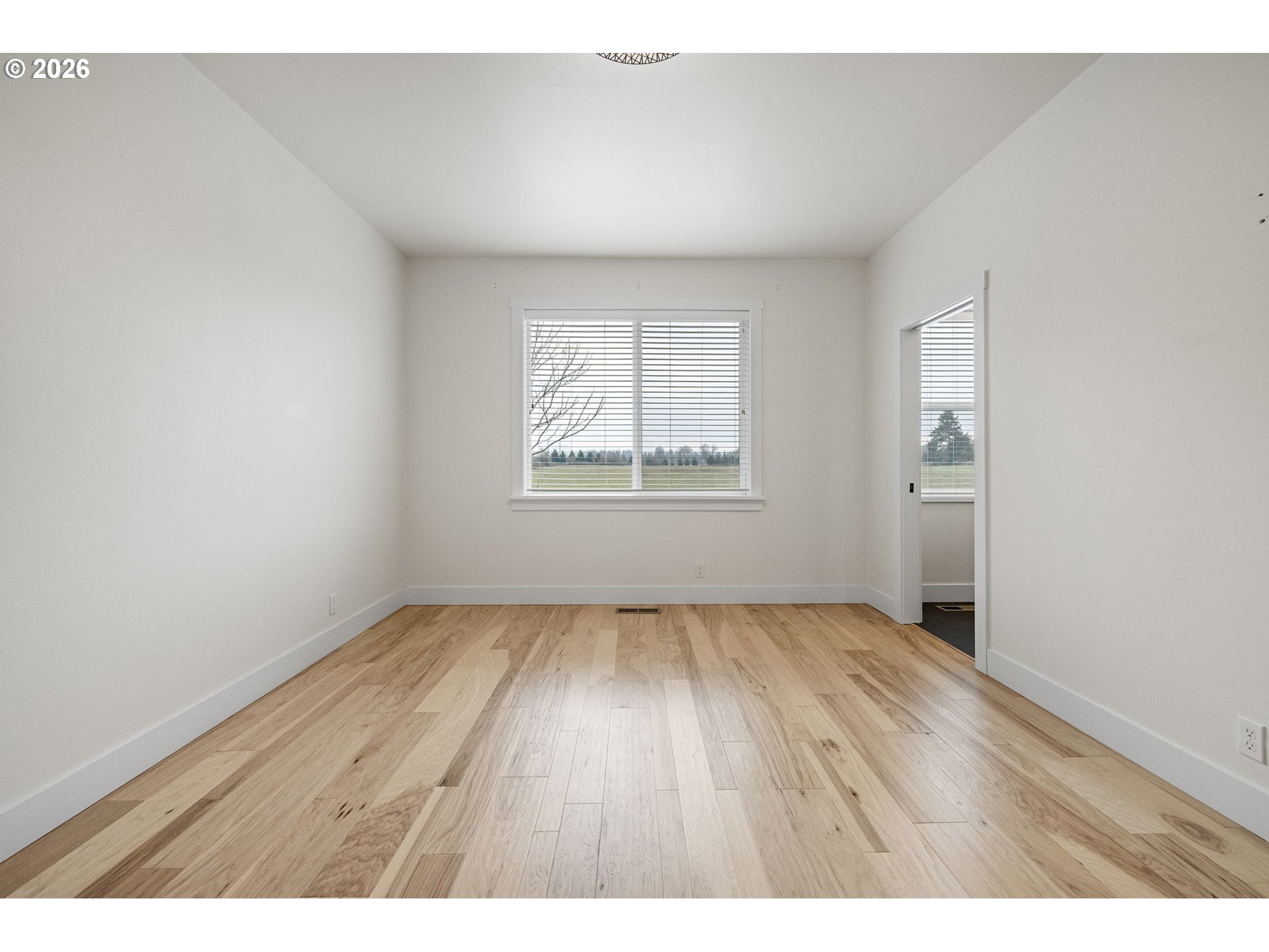 3340 Zane Lane Eugene, OR 97404 - Photo 12 of 37 an empty room with wooden floor and windows