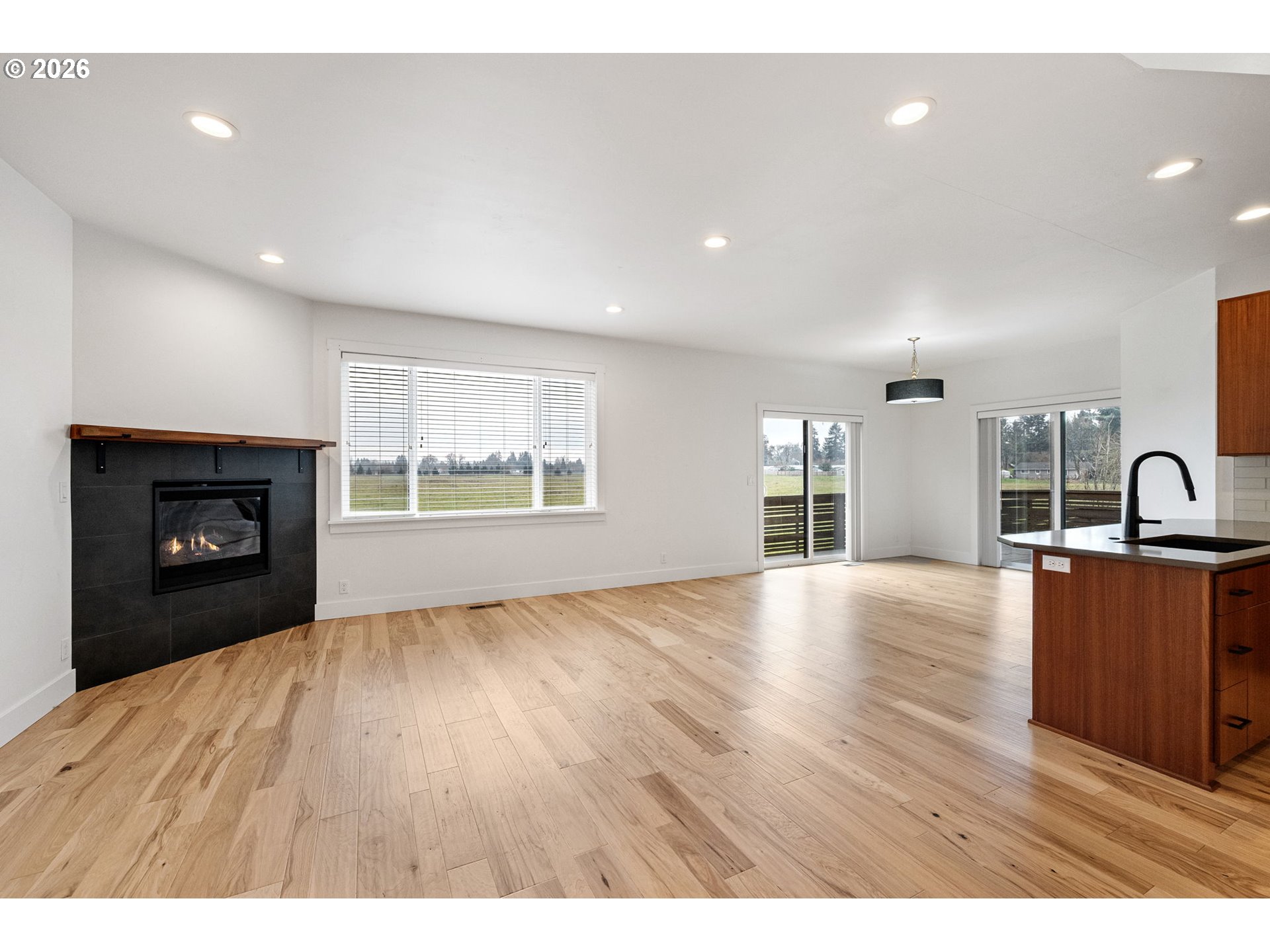 3340 Zane Lane Eugene, OR 97404 - Photo 18 of 37 a view of an empty room with a fireplace and a window