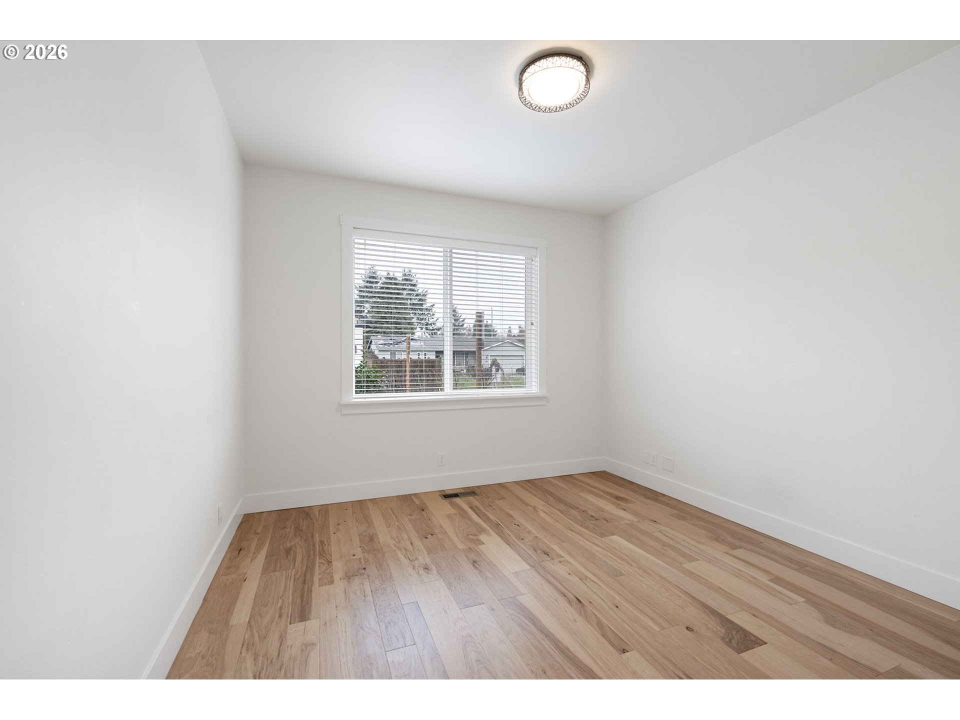 3340 Zane Lane Eugene, OR 97404 - Photo 5 of 37 a view of an empty room with wooden floor and a window