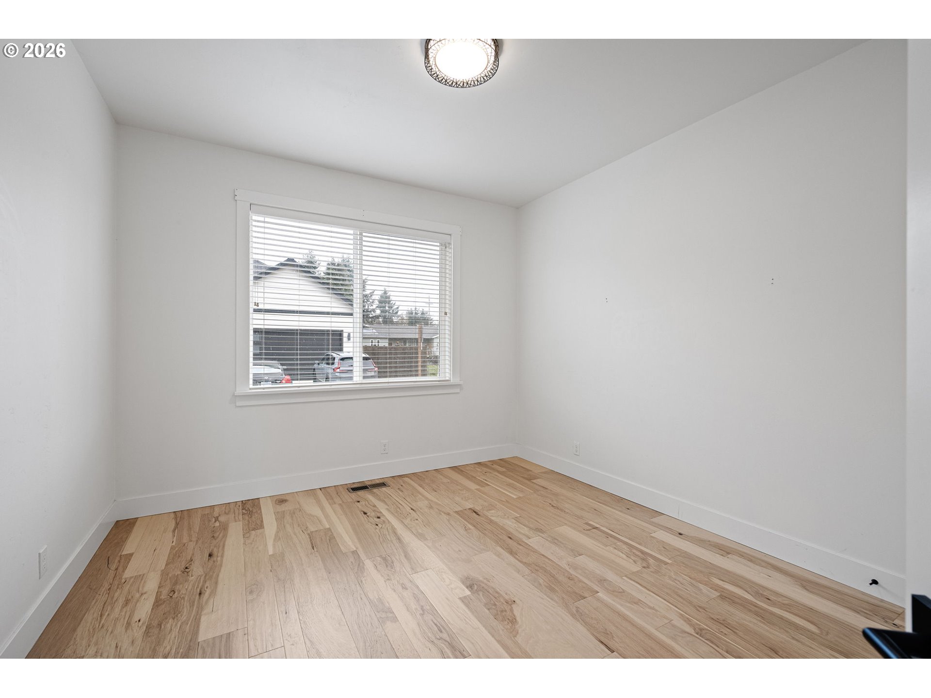 3340 Zane Lane Eugene, OR 97404 - Photo 7 of 37 a view of an empty room with wooden floor and a window