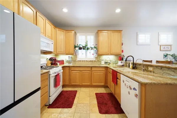 a kitchen with stainless steel appliances granite countertop a sink and cabinets