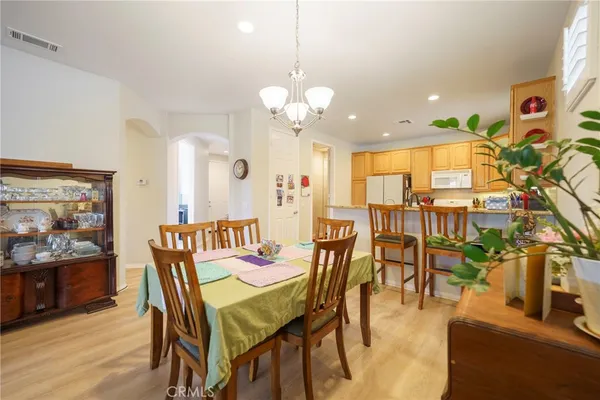 a view of a dining room with furniture and chandelier