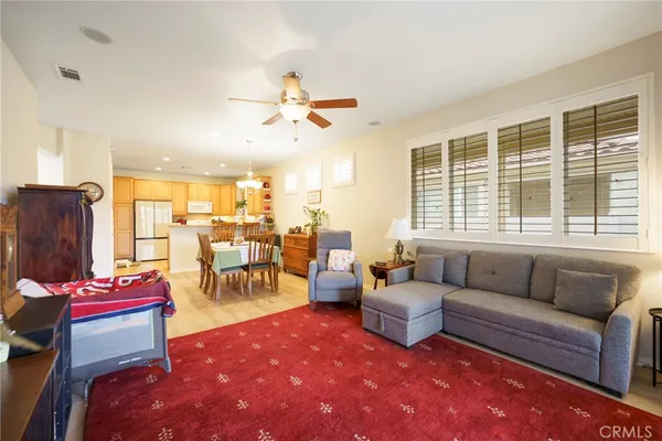 a living room with furniture a dining table and a fireplace