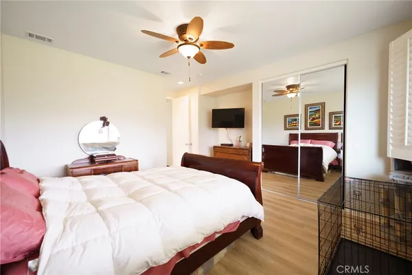 a bedroom with a bed and wooden floor