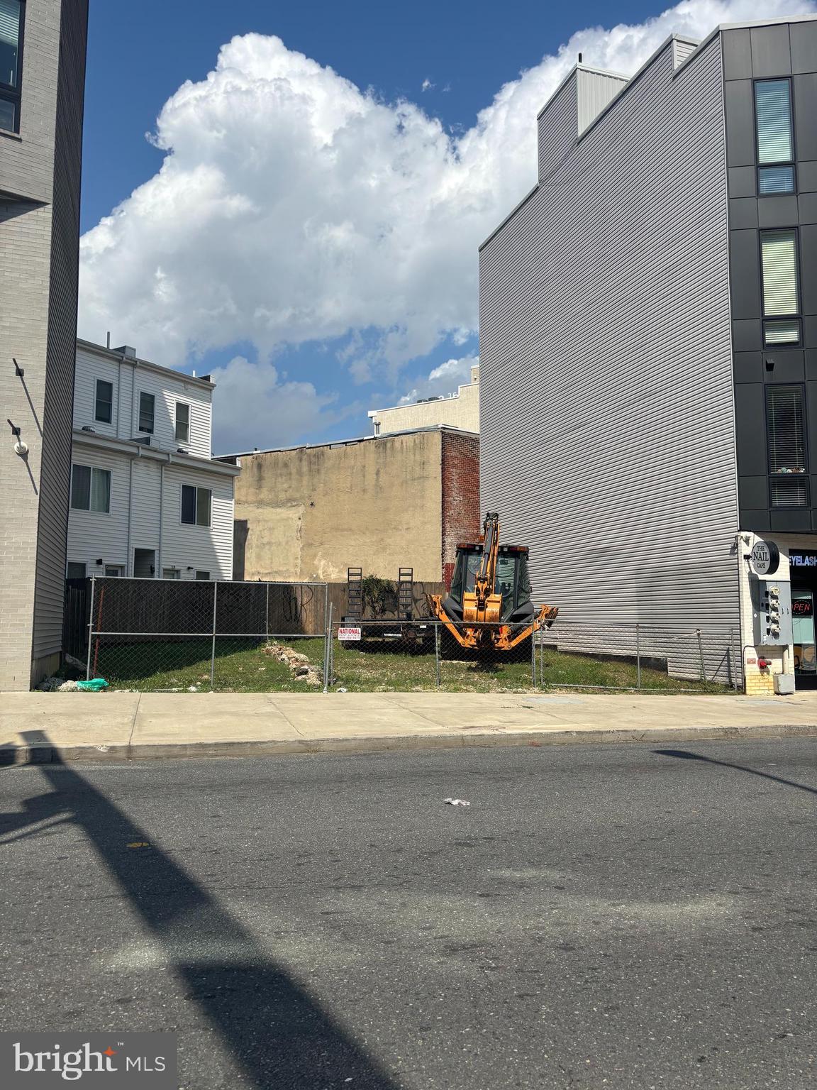 a view of a building with car parked on the road