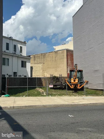 a view of a street with a car parked in front of it