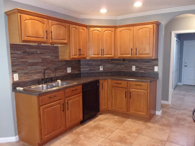 a kitchen with stainless steel appliances granite countertop a sink and cabinets