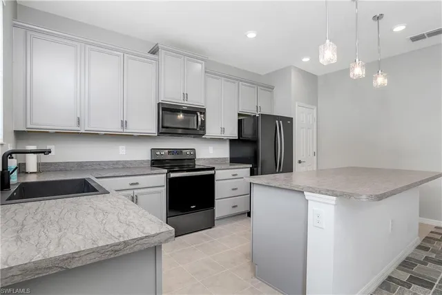 a kitchen with a sink stove and refrigerator