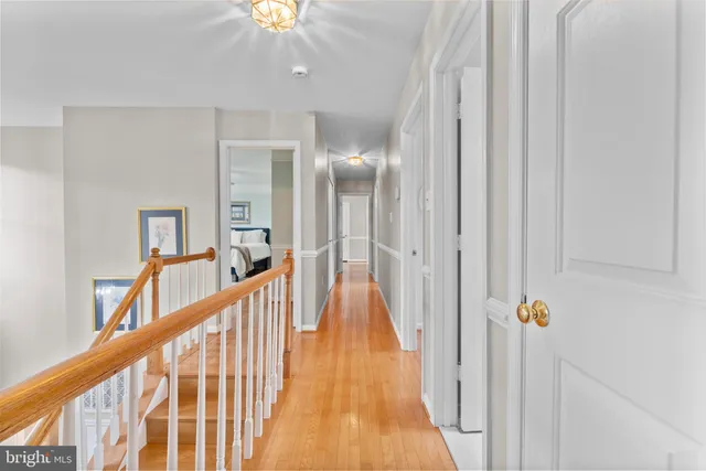 a spacious bedroom with a large bed and a chandelier