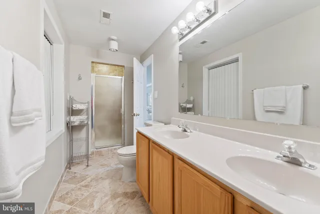 a view of a patio with a table and chairs under an umbrella