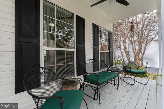 a large kitchen with stainless steel appliances granite countertop a stove a sink dishwasher and white cabinets with wooden floor