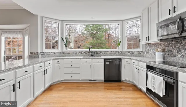 a kitchen with stainless steel appliances a refrigerator sink and cabinets