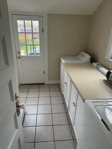 a view of a livingroom with white furniture