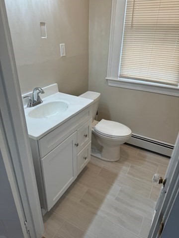 7 Lowell Street, Unit A Woburn, MA 01801 - Photo 15 of 17 a bathroom with a toilet sink and mirror