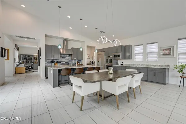 a kitchen with stainless steel appliances kitchen island granite countertop a sink and cabinets