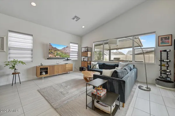 a living room with furniture gym equipment and large window