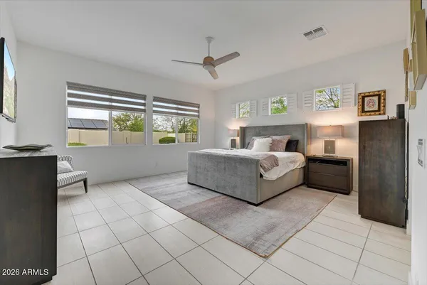 a spacious bedroom with a bed and window