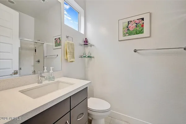 a bathroom with a sink mirror vanity and toilet