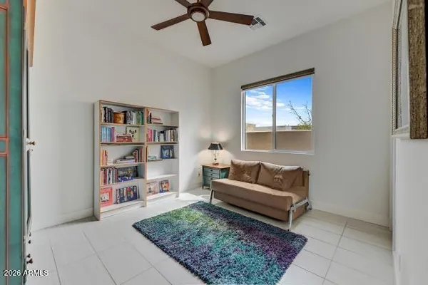 a living room with a couch and a book shelf