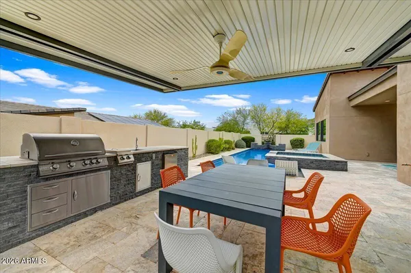 a kitchen with stainless steel appliances wooden floor dining table and chairs