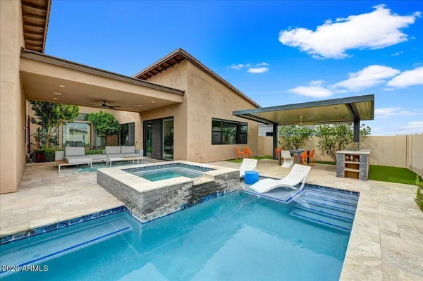 a living room with patio furniture and a large window
