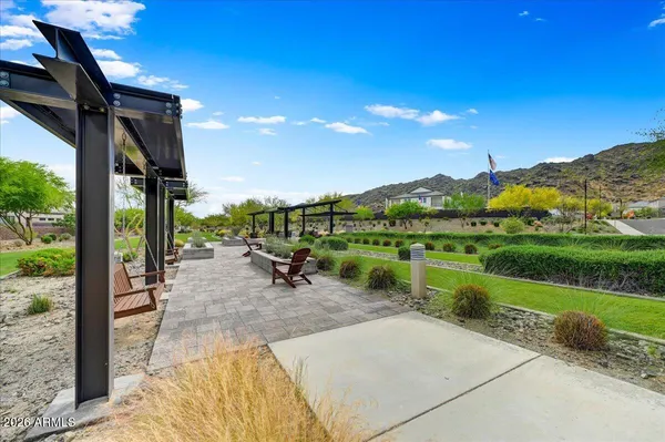 a view of a patio with a table and chairs under an umbrella