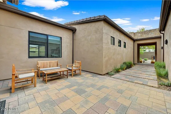 a backyard of a house with barbeque oven table and chairs