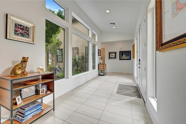 a view of a hallway with workspace and windows