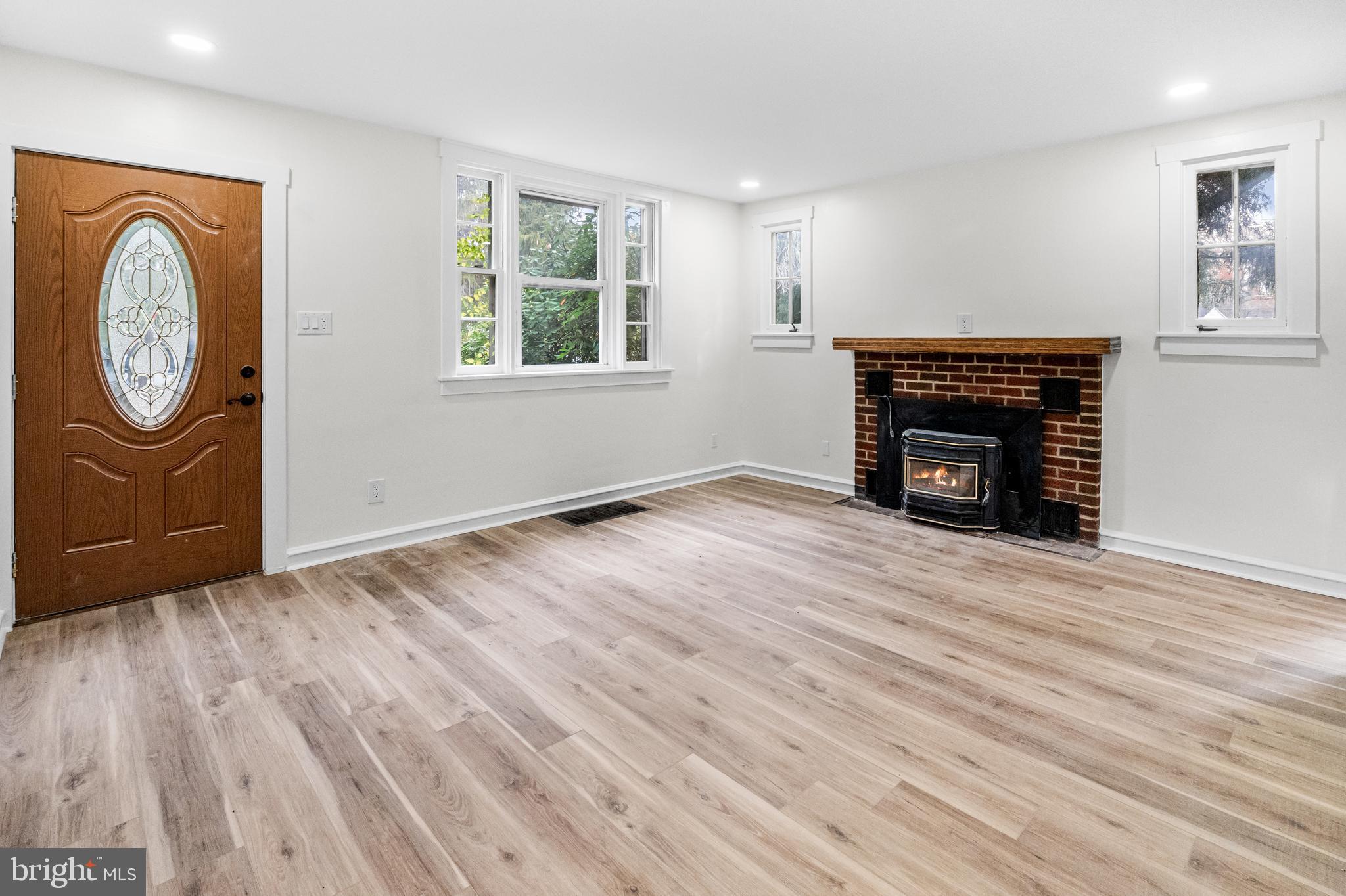 3500 Eisenbrown Road Reading, PA 19605 - Photo 3 of 34 an empty room with wooden floor a fireplace and windows