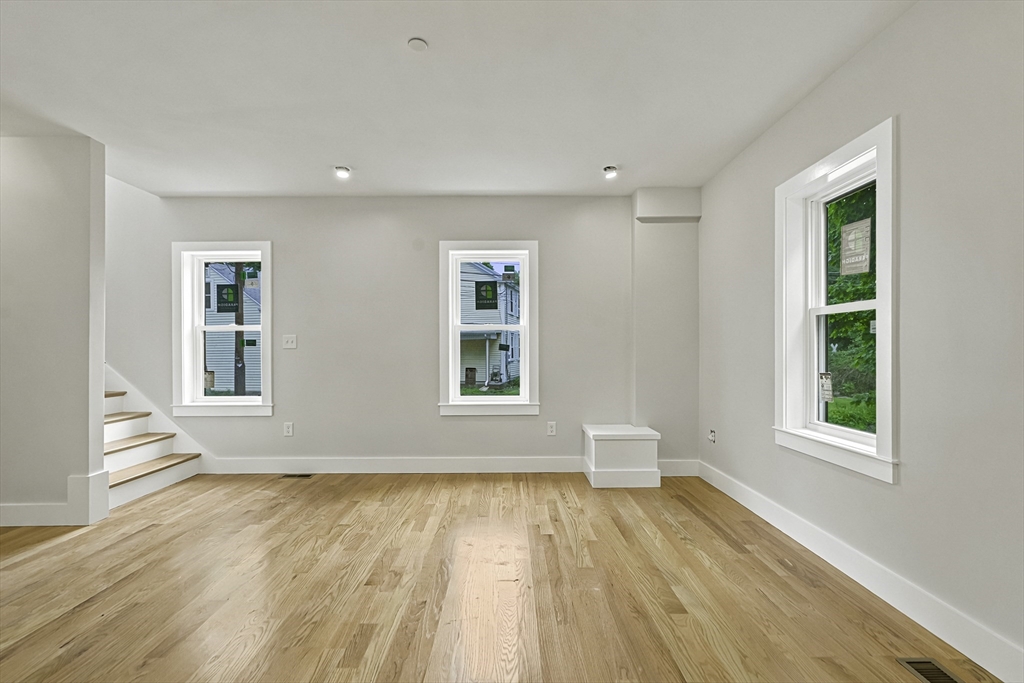 4 Mayhew Street Framingham, MA 01702 - Photo 8 of 42 an empty room with wooden floor and windows