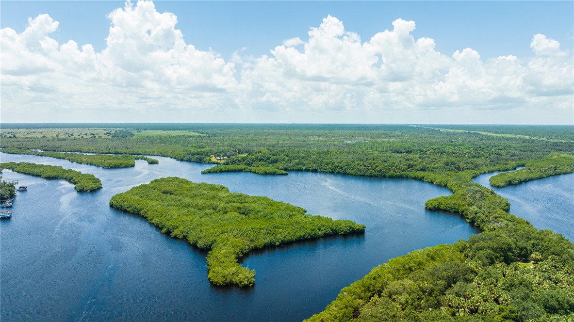 None Islands Melbourne, FL 32901 - Photo 4 of 8 an aerial view of lake residential house with outdoor space and trees around