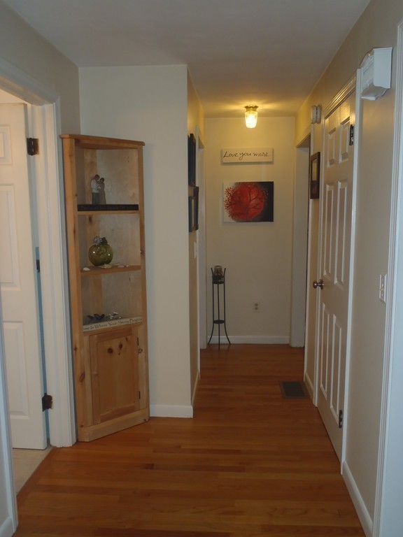 19 Wilbraham Road Monson, MA 01057 - Photo 12 of 29 a view of a hallway with wooden floor and closet
