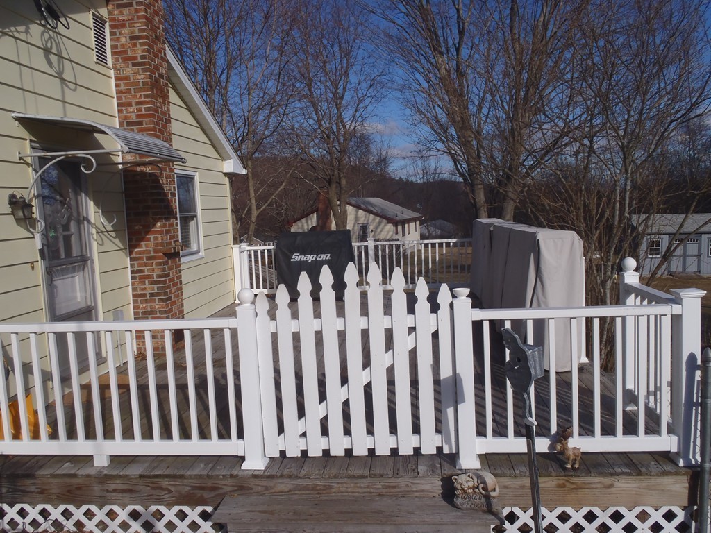 19 Wilbraham Road Monson, MA 01057 - Photo 8 of 29 a view of a house with a wooden bench