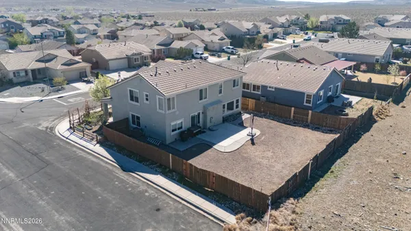 an aerial view of a house with a big yard