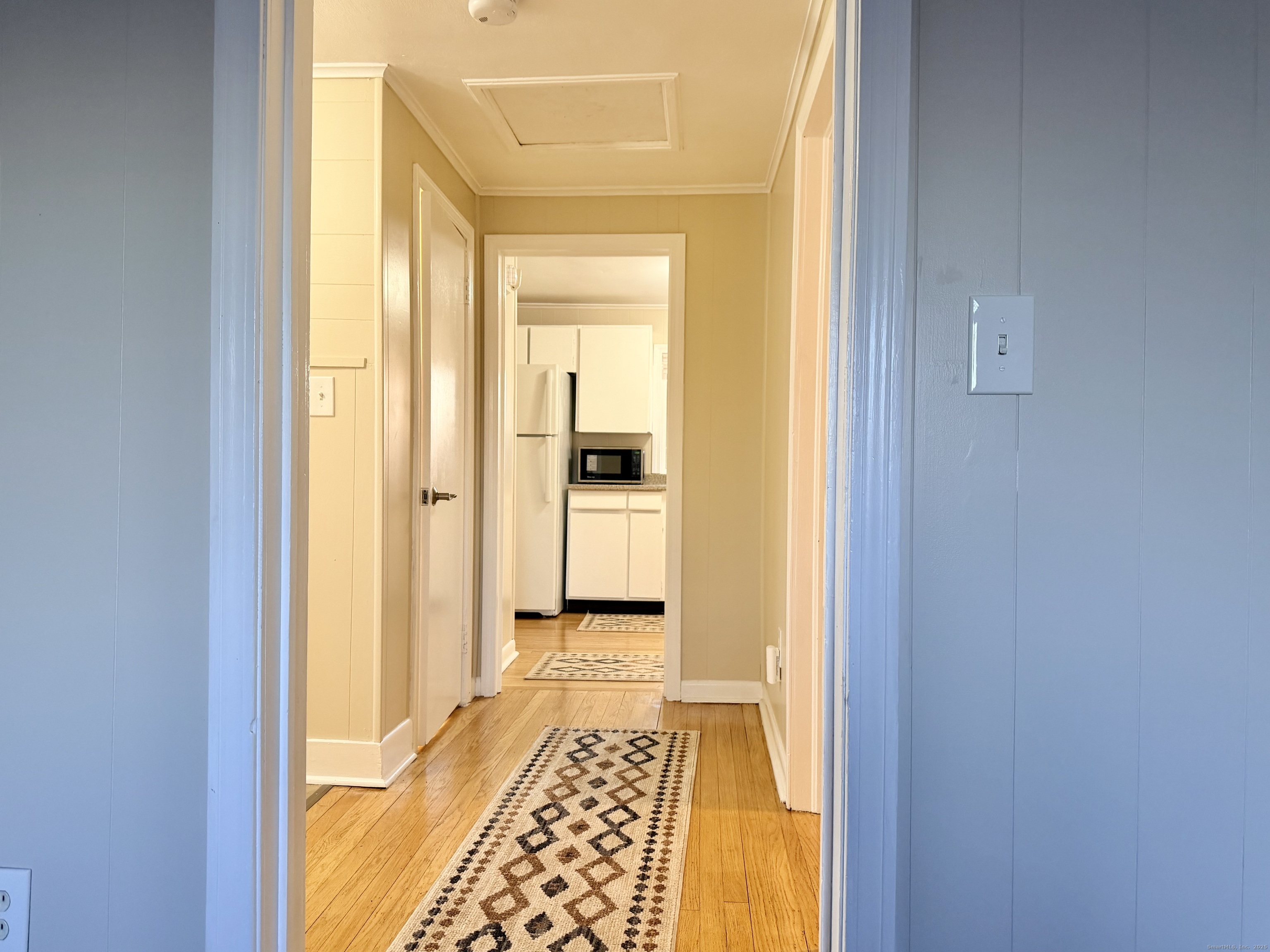 12 Clark Lane, Unit A Waterford, CT 06385 - Photo 15 of 20 a view of a hallway with wooden floor and a bathroom
