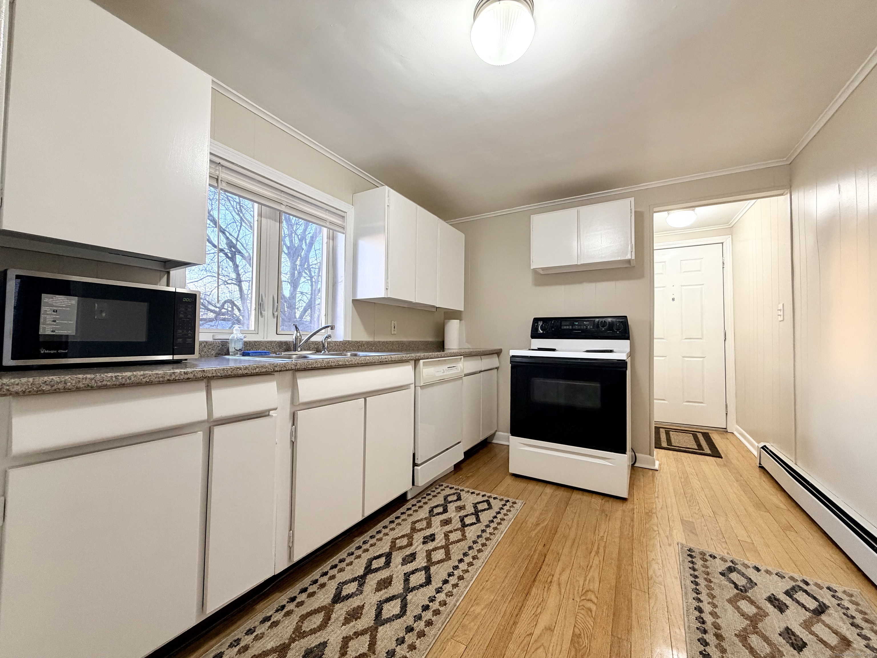 12 Clark Lane, Unit A Waterford, CT 06385 - Photo 4 of 20 a kitchen with a sink stove and microwave
