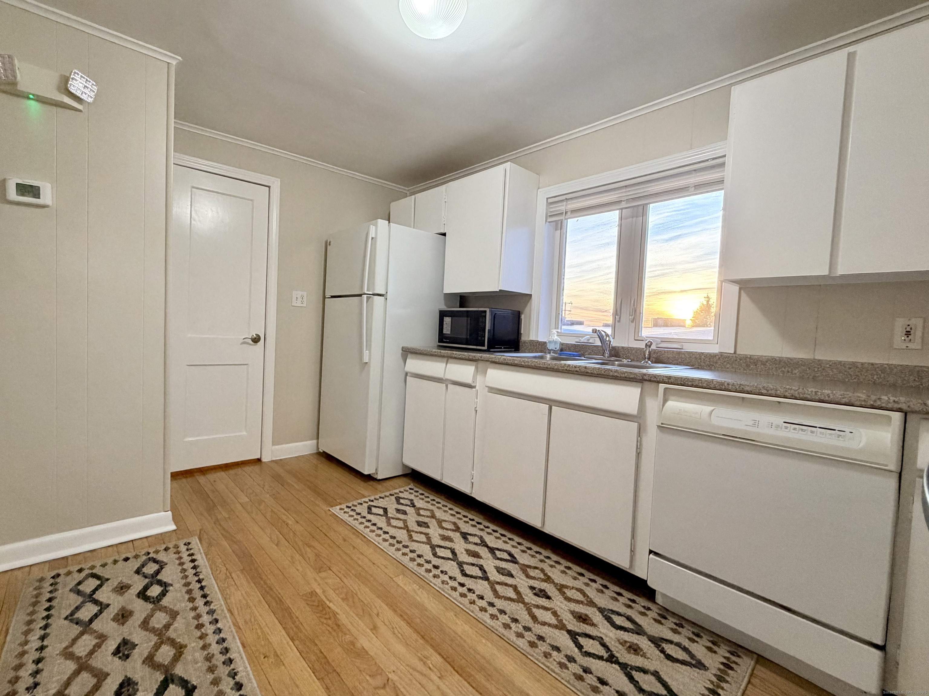 12 Clark Lane, Unit A Waterford, CT 06385 - Photo 6 of 20 a kitchen with granite countertop a sink cabinets stainless steel appliances and a window