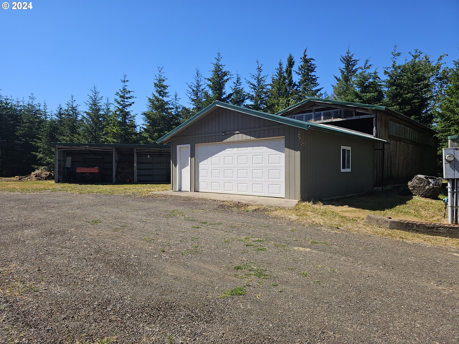 7305 Ash Street Grand Ronde, OR 97347 - Photo 26 of 47 a front view of a house with a yard and garage