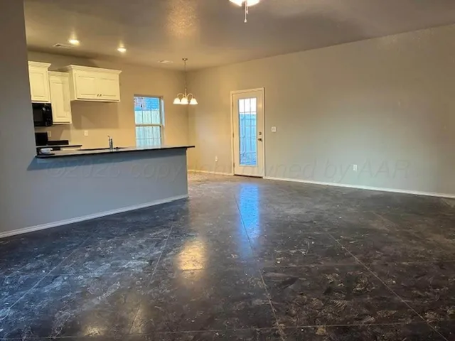 a view of a kitchen with a sink and a window
