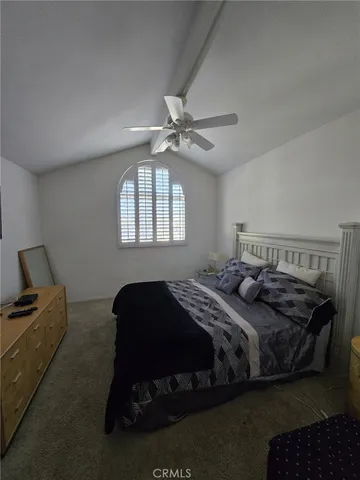 a bedroom with a bed dresser and a window
