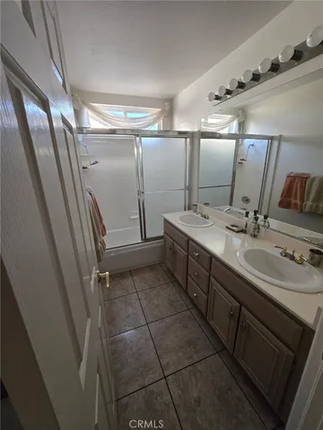 a bathroom with a double vanity sink and mirror